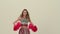 Rehearsal dance of a cheerleader in uniform on a white studio background. The cheerleader dances an uplifting dance