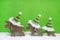 Reindeer family on green and white wooden christmas background w