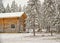 Reindeer near timber house in winter Lapland