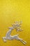 Reindeer and white berry Christmas decoration on yellow glitter background