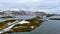 Reine artic bridge with fishing boat, Norway winter aerial 4k video Lofoten Archipelago