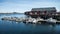 Reine, Norway - June 2, 2016: Traditional fishing boat with red rorbu fishing houses on Lofoten islands in Norway