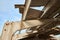 Reinforced concrete beams and a dilapidated roof of an unfinished farm for livestock