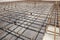 Reinforcement rods at construction site. Steel rebar mesh close up. Rusty steel reinforcement bars for concrete foundation or