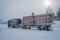 Reinli, Norway - March 26, 2018: Outdoor view of huge truck transport trunks or lumber in a road in Valdres region