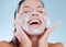 Reinvigorate, renew and restore your senses. Studio shot of a young woman washing her face while taking a shower against