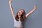 Rejoicing young woman screaming with joy celebrating victory win success isolated on grey background