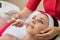 Rejuvenating facial treatment. Model getting lifting therapy massage in a beauty SPA salon