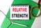 RELATIVE STRENGTH text on notebook on green paper