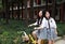 Relax Asian Chinese pretty girls wear student suit in school enjoy free time ride bike in nature spring garden