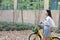 Relax Asian Chinese pretty girls wear student suit in school enjoy free time ride bike in nature spring garden