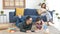 Relax Asian mother reading a book on sofa and father with daughter using tablet in living room at home