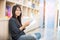 Relax asian woman reading book sitting on sofa in living room holding book to read. Young woman relaxation reader reading open