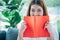 Relax asian woman reading book sitting on sofa in living room holding book to read. Young woman relaxation reader reading open