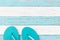 Relax background for summer beach holiday with turquoise sandals on blue white striped wood