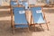 Relax blue white beach seat chairs on sand on river coast of vichy city in France