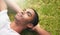 Relax, chill out and unwind. a young man relaxing on the grass outdoors.