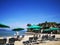 Relax and enjoy on the beach with lazy chairs on beach and beautiful blue sky above.