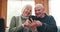 Relax, home and senior couple with smartphone, retirement and conversation with connection, social media or typing