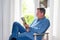 Relax middle aged profile man reading book at home front light windows