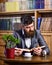 Relax, pleasure, leisure, hobby concept. Bearded man in luxury suit in public library.