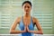 Relax and regenerate with yoga. a young woman meditating while doing yoga at home.