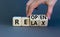 Relax and reopen symbol. Businessman turns cubes and changes the word `relax` to `reopen`. Beautiful grey table, grey backgrou