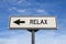 Relax road sign, arrow on blue sky background