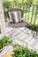 Relax zone on a balcony with a chair, rug and plants.