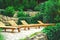 Relaxation area with wooden sunbeds surrounded by lush greenery