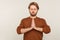 Relaxation, balanced mind. Portrait of peaceful man with beard wearing sweatshirt standing calm down with prayer gesture