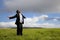 Relaxation businessman standing on the meadow