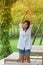 Relaxation Concept : Asian woman wear white shirt and stretch in the garden with sunlight background.