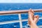 Relaxation on cruise ship travel holiday. Closeup of women feet up on balcony overlooking ocean view on caribbean vacation at sea