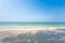 Relaxation seascape. Scenic tropical beach in summer season. Beautiful waves, shadow and light blue sky. Sunshine day. Trat,