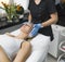 Relaxation in SPA facility. Square indoor shot of young pregnant caucasian woman lying down on SPA bed. Unrecognizable