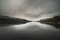 Relaxation and state of mind: Glencar Lough reflection of low clouds in the lake amidst tranquility, Ireland