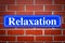 Relaxation street sign on brick wall