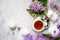 Relaxation time concept. Homemade zephyr with cup of tea on a cozy kitchen table. Copy space, top view flat lay background