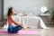 Relaxation. Yoga at home - full length portrait of a woman.