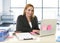 Relaxed 40s woman with blond hair smiling confident sitting on office chair working at laptop computer