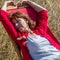 Relaxed 50s woman enjoying sun warmth on her deckchair