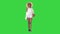 Relaxed african american girl walking wearing a straw hat and a bag on a Green Screen, Chroma Key.