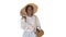 Relaxed african american girl walking wearing a straw hat and a bag on white background.