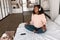 Relaxed African American Lady Meditating Wearing Headphones In Bedroom