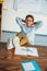 relaxed african-american schoolboy sitting with feet