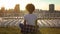 Relaxed african american woman sitting in lotus pose, meditating at sunset, rest