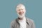 Relaxed albino guy listening music in bluetooth earpods, standing with closed eyes over turquoise background