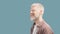 Relaxed albino man listening music in wireless airpods earphones on turquoise background, panorama with free space