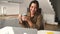 Relaxed asian multiracial female freelancer relaxing sitting with cup of coffee in front of laptop